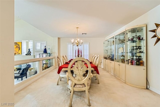 carpeted dining space with a notable chandelier