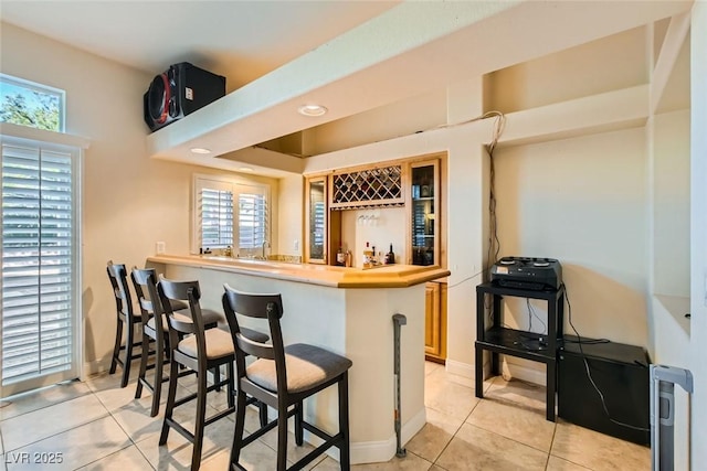 bar featuring light tile patterned floors