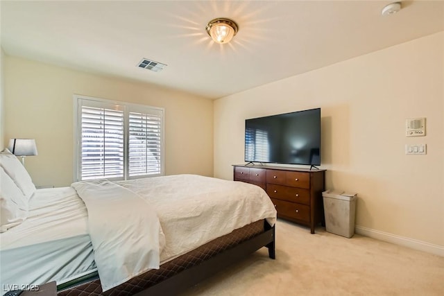 bedroom featuring light colored carpet