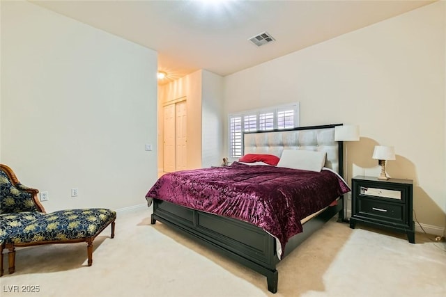 bedroom featuring light colored carpet and a closet