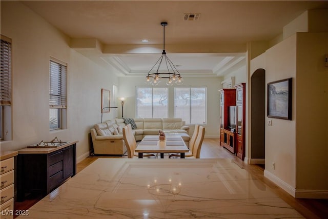 dining space featuring light hardwood / wood-style floors and a notable chandelier