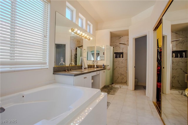 bathroom with independent shower and bath, vanity, and tile patterned floors