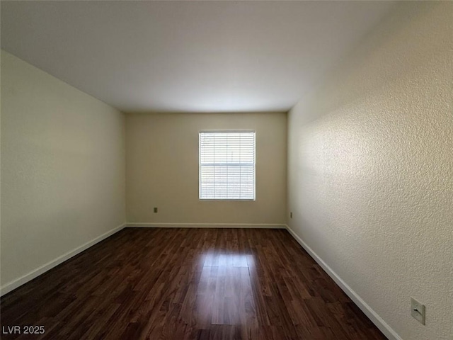 empty room featuring dark hardwood / wood-style flooring