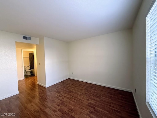 unfurnished room featuring dark wood-type flooring