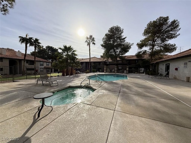 view of swimming pool with a hot tub and a patio