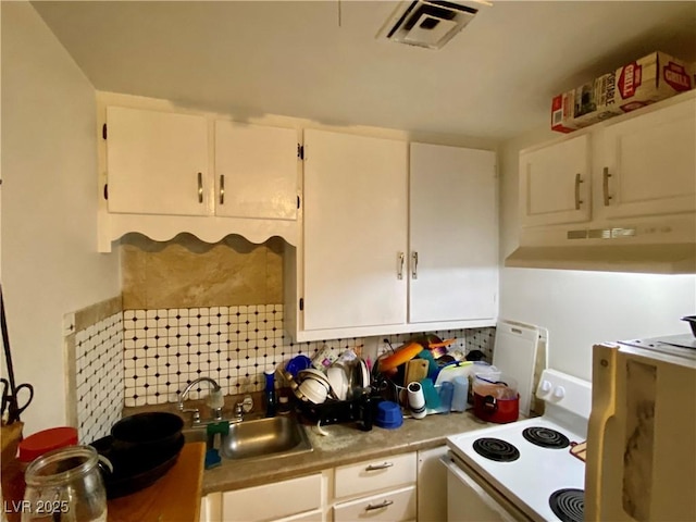 kitchen featuring sink, backsplash, white cabinetry, and electric stove