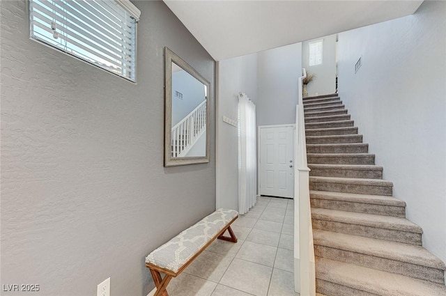 stairway featuring tile patterned floors