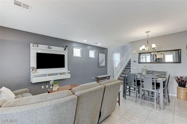 living room featuring a notable chandelier and light tile patterned floors