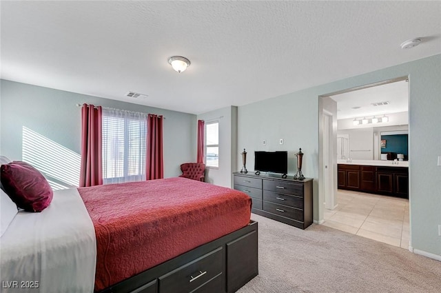 carpeted bedroom with ensuite bathroom