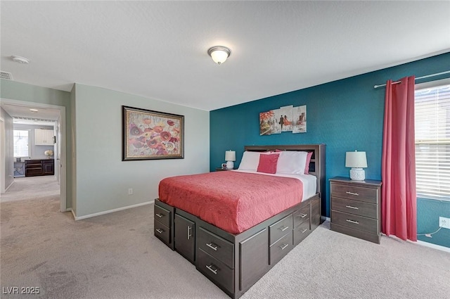 bedroom with light colored carpet and multiple windows