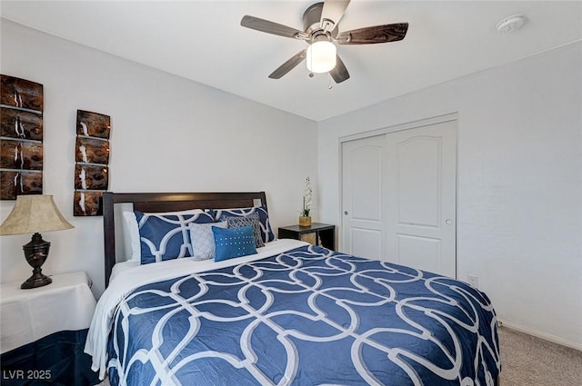 carpeted bedroom featuring ceiling fan and a closet