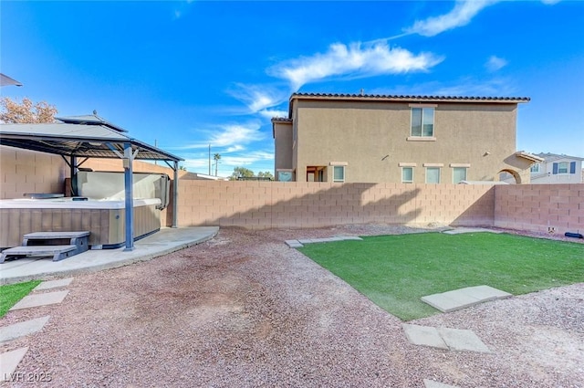 view of yard featuring a gazebo and a hot tub