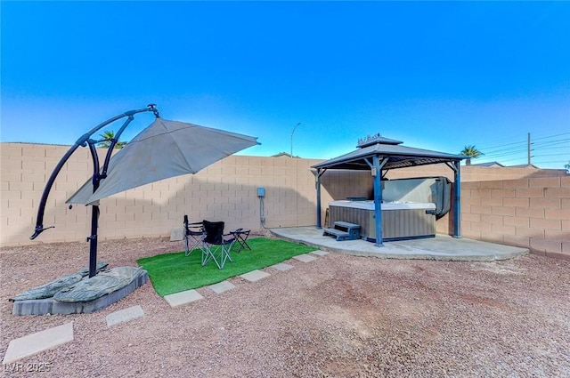 exterior space featuring a gazebo, central AC unit, a patio area, and a hot tub