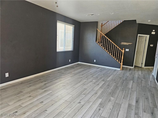 unfurnished room with light wood-type flooring