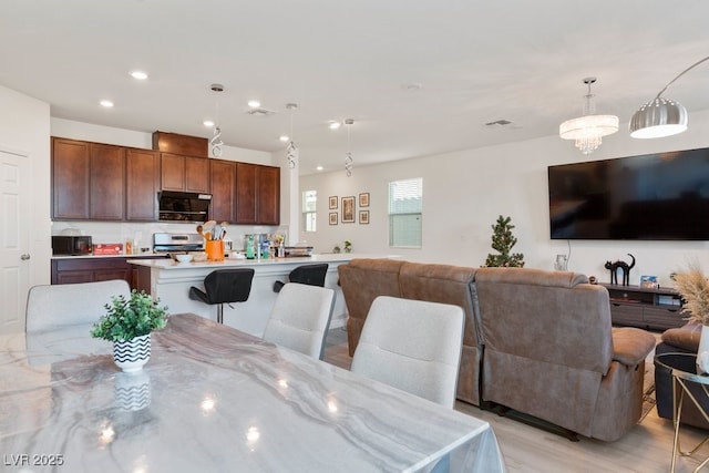 dining room featuring light hardwood / wood-style floors and an inviting chandelier