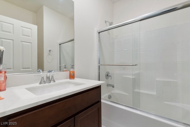 bathroom with vanity and combined bath / shower with glass door