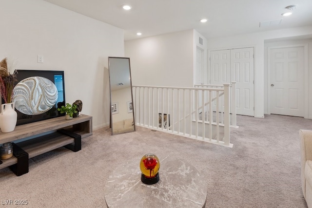 sitting room featuring light carpet