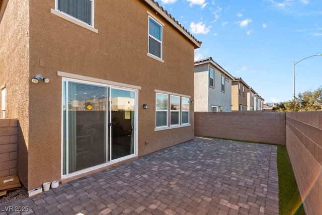 rear view of property featuring a patio area