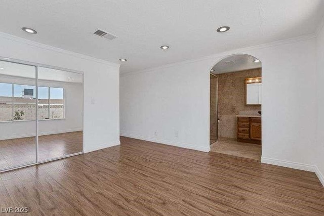 unfurnished room featuring dark hardwood / wood-style floors and crown molding