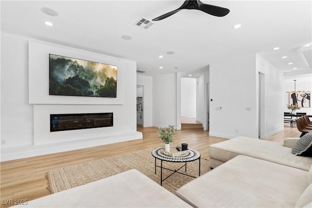 living room featuring ceiling fan and light wood-type flooring