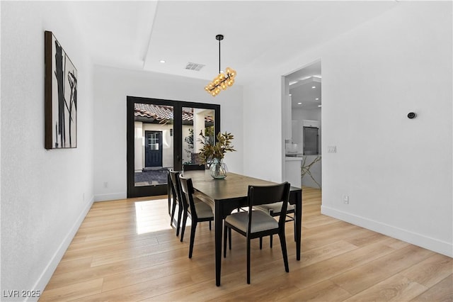 dining room featuring french doors and light wood-type flooring