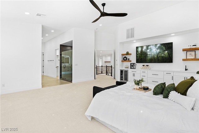 carpeted bedroom with ceiling fan and beverage cooler