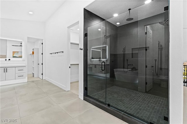 bathroom with a shower with door, vanity, and vaulted ceiling