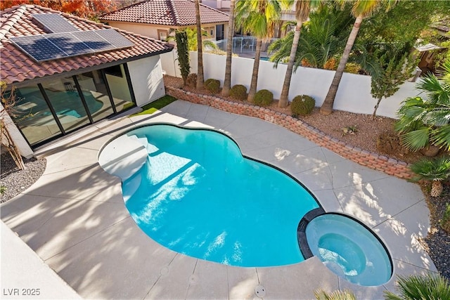 view of pool featuring an in ground hot tub