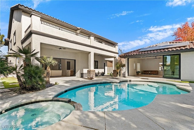 view of pool featuring an in ground hot tub, a patio, and ceiling fan