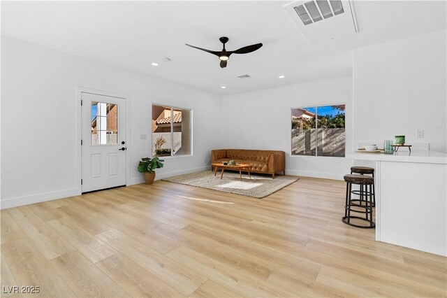 unfurnished room featuring ceiling fan, light hardwood / wood-style floors, and plenty of natural light