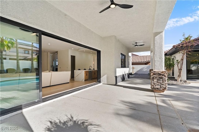 view of patio featuring ceiling fan