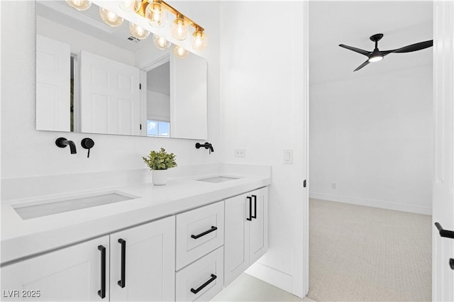 bathroom featuring ceiling fan with notable chandelier and vanity