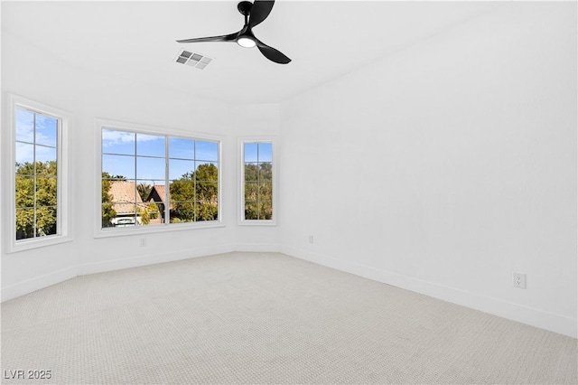 carpeted spare room featuring ceiling fan