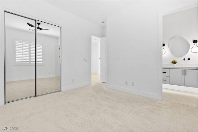 unfurnished bedroom with a closet and light colored carpet