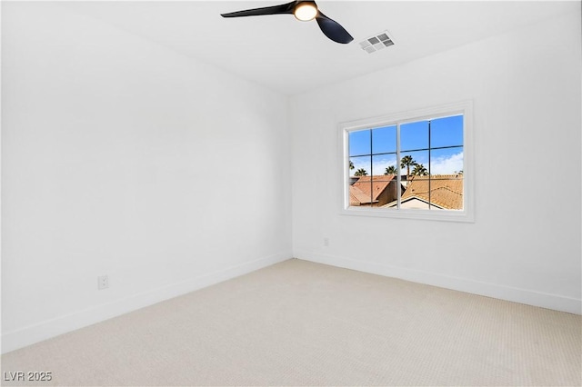 unfurnished room featuring ceiling fan and carpet