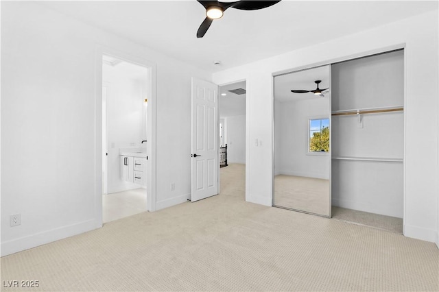 unfurnished bedroom featuring ceiling fan, a closet, and light colored carpet