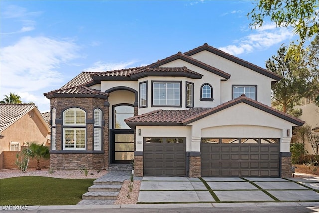 mediterranean / spanish home featuring a garage