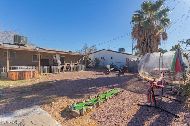 view of yard featuring central AC and a jacuzzi