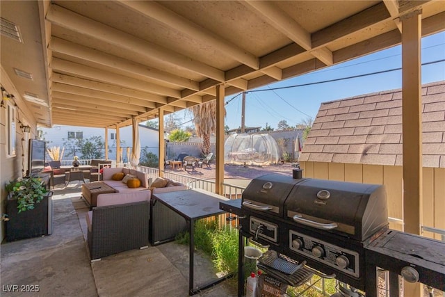 view of patio / terrace with a grill and an outdoor living space with a fire pit