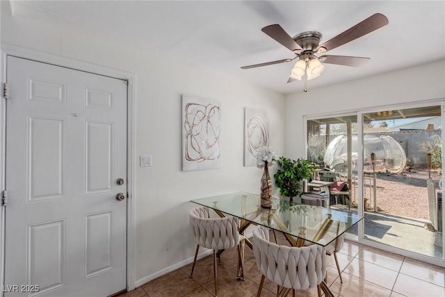 tiled dining area with a healthy amount of sunlight and ceiling fan