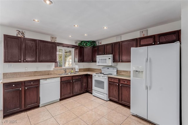 kitchen featuring white appliances, sink, and light tile patterned floors