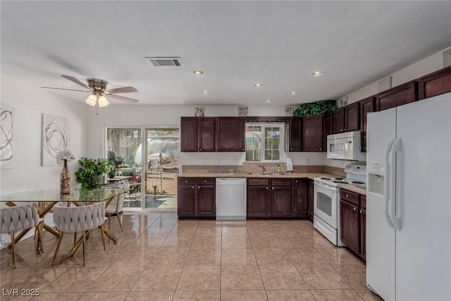 kitchen with ceiling fan, sink, white appliances, and a healthy amount of sunlight