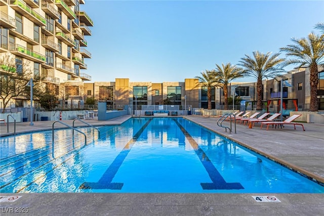 view of pool featuring fence and a patio