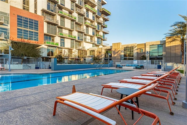 pool featuring a patio and fence