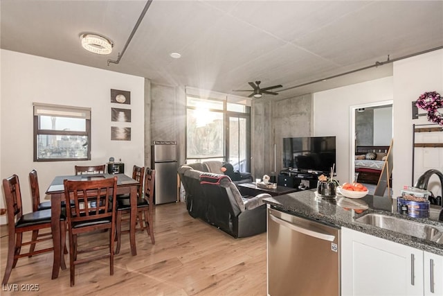 living room featuring ceiling fan and light wood-style flooring