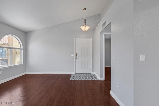 entrance foyer featuring dark hardwood / wood-style flooring and lofted ceiling