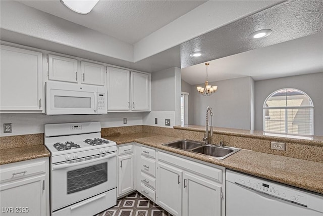 kitchen with white appliances, white cabinets, sink, a textured ceiling, and a chandelier