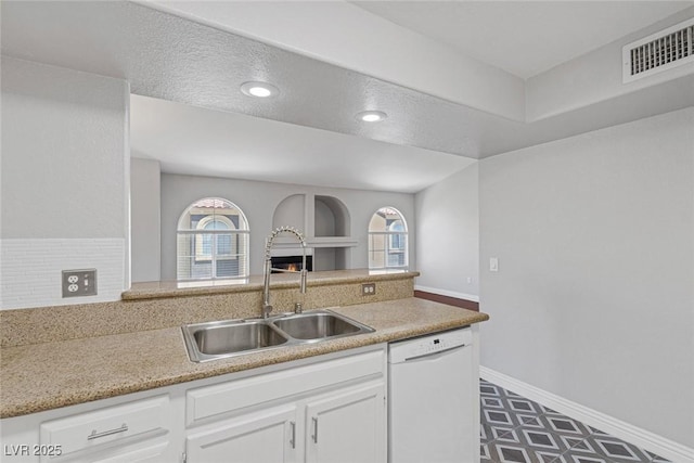 kitchen with white cabinetry, dishwasher, a healthy amount of sunlight, and sink