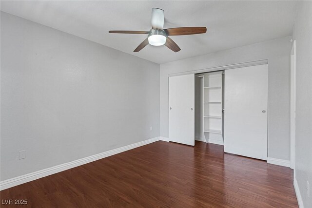 unfurnished bedroom featuring ceiling fan, a closet, and dark hardwood / wood-style floors