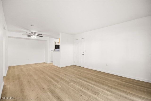 unfurnished room featuring ceiling fan and light wood-type flooring